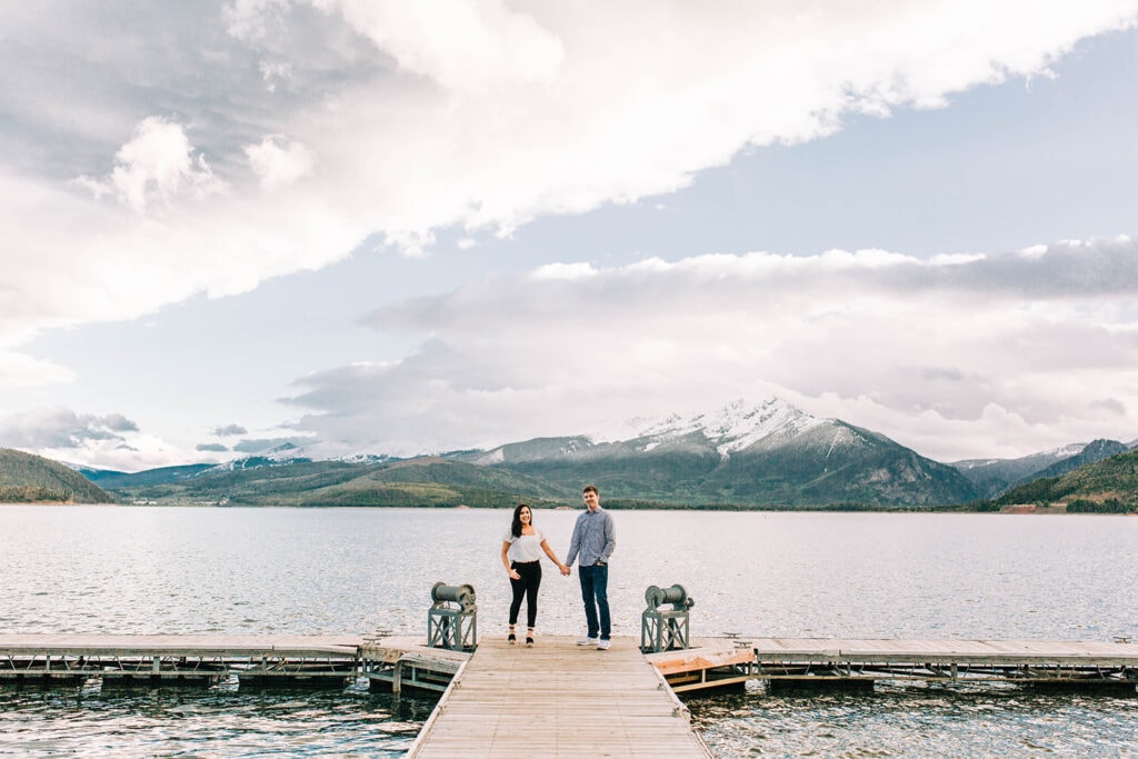 Engagement photo of couple with lake dillon and mountains in background