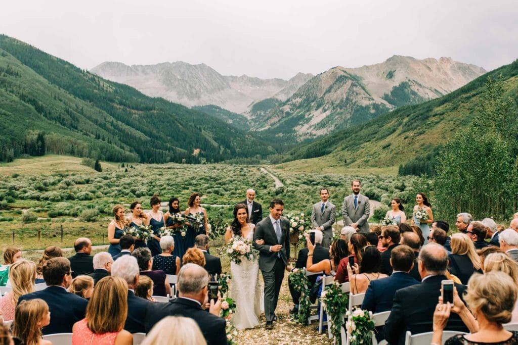 photo of couple walking down the aisle at outdoor ceremony at Pine Creek Cookhouse