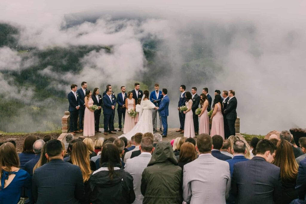 Photo of the Vail wedding deck ceremony with low hanging clouds