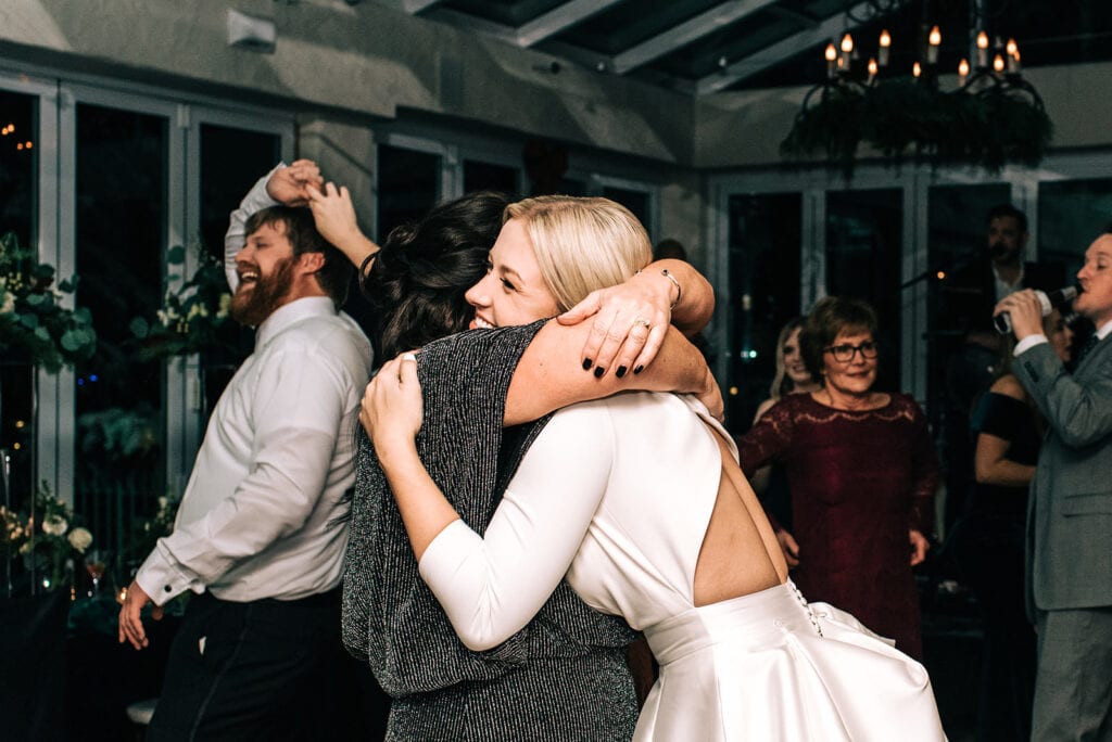 Candid wedding photos from indoor reception at The Sonnenalp in Vail with black and green velvet decor