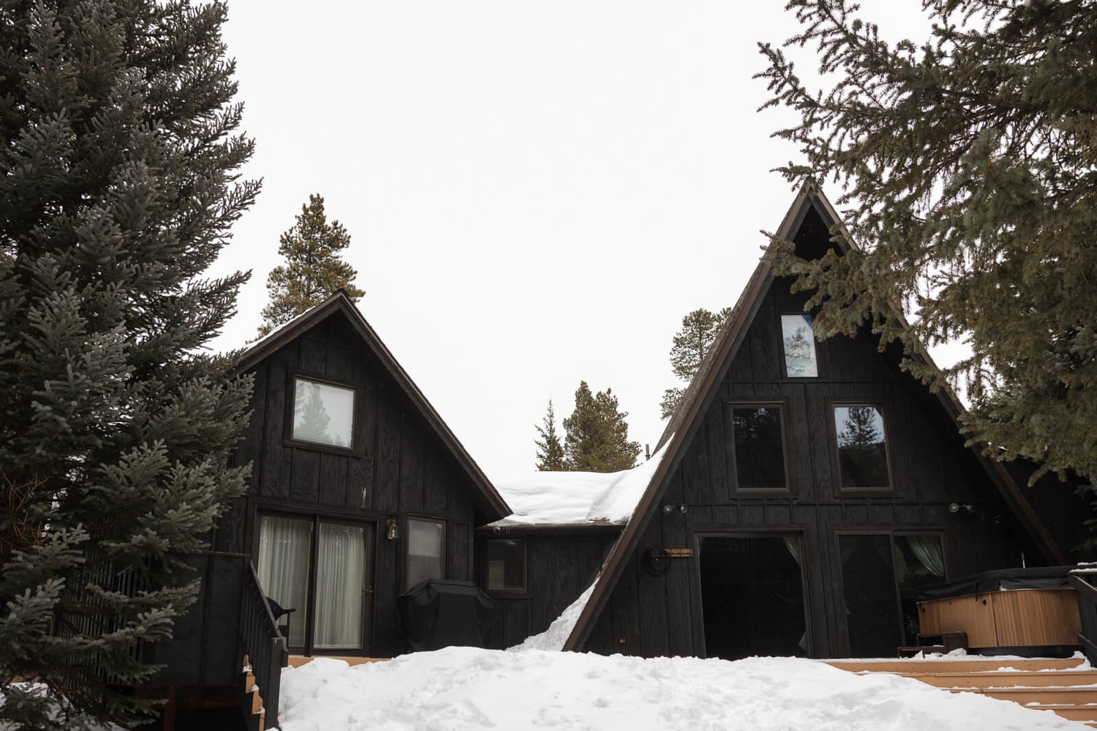 Cute, dark charcoal a frame cabin in Breckenridge in the snow with hot tub